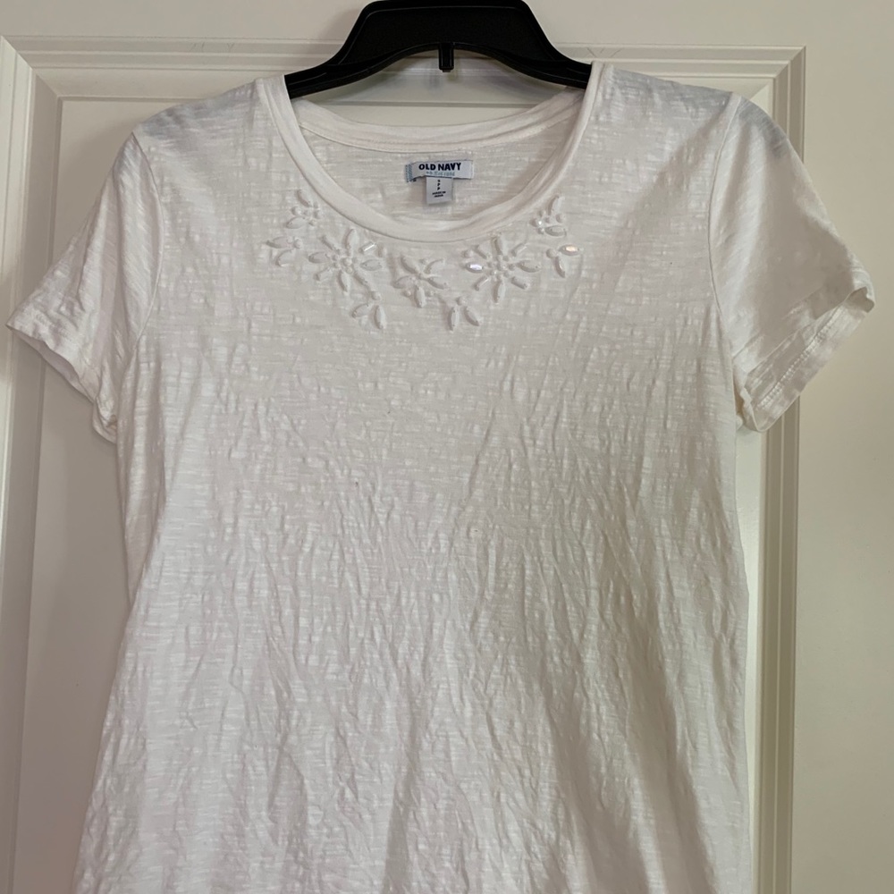 White shirt with embellished collar.